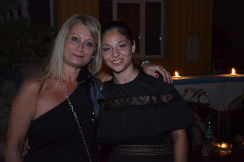 two women standing next to each other at a party at Ostello Salento in Alezio