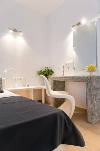 a bedroom with a sink and a mirror at Villa Irena Bianca in Naousa
