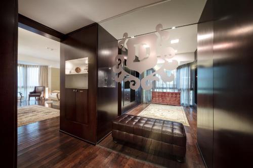 a lobby with a leather couch in a room at The Dostyk Hotel in Almaty