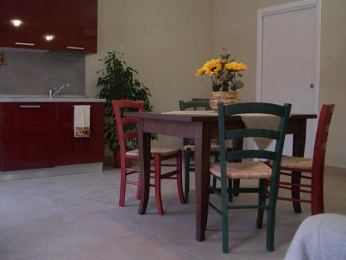 a kitchen with a table with chairs and a sink at Agriturismo la Sforzata in Collegno