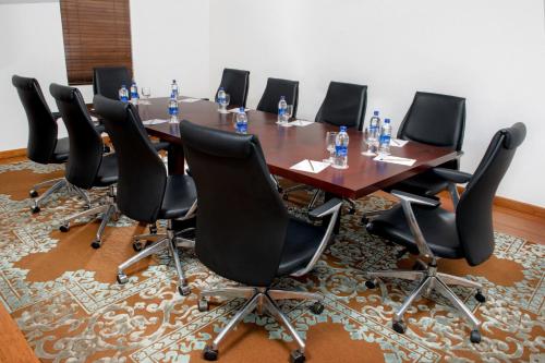 a conference room with a long table and chairs at Vivanta Colombo, Airport Garden in Negombo