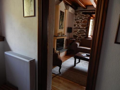 a room with a living room with a fireplace at Seirios in Vizitsa