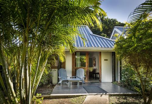 a house with two chairs and a table on a patio at Wellesley Resort Fiji in Vunaniu