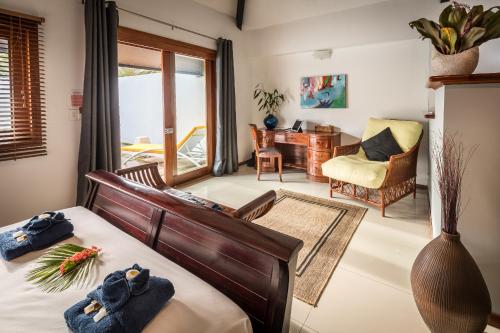 a bedroom with a bed with towels on it at Wellesley Resort Fiji in Vunaniu