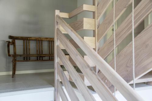 a wooden staircase in a room with a bench at Ca Muretta Relais in Bardolino