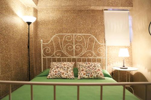a bedroom with a bed with two pillows on it at Casa da Avó in Elvas