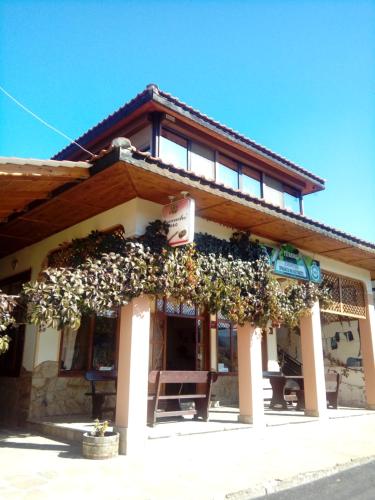 a building with flowers on the front of it at Guest House Ambrozia in Kotel