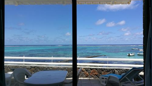 a view of the ocean from a room with a window at Blue Beryl Guest House in Blue Bay
