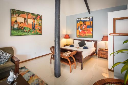 a room with a bed and a table in it at Wellesley Resort Fiji in Vunaniu