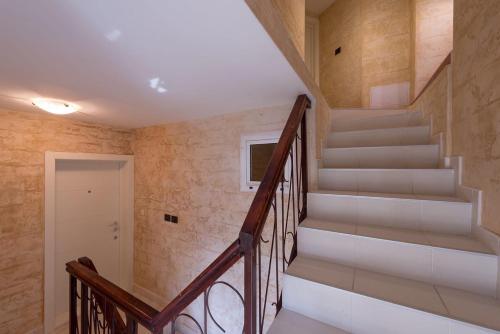 a staircase in a home with a stair case at Kotor old town Palace Bucha in Kotor