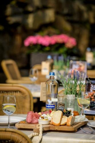 a table with a plate of food and a glass of wine at Campanile Hotel & Restaurant Venlo in Venlo