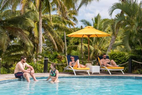a group of people sitting in a swimming pool at Wellesley Resort Fiji in Vunaniu