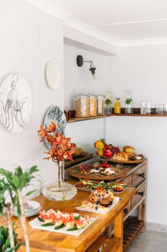 a table with many plates of food on it at Linhof Boutique Guest House in Paternoster