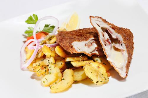 a sandwich and french fries on a white plate at Steinegger Eppan in Appiano sulla Strada del Vino