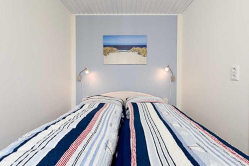 ベンサージールにあるFerienwohnung Perlmuschelの白いベッドルーム(ランプ2つ付きのベッド1台付)