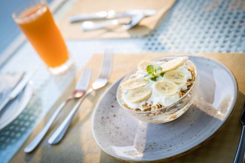 a bowl of food with bananas and nuts on a table at Wellesley Resort Fiji in Vunaniu