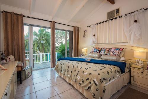 a bedroom with a bed and a large window at Ruby Sands Exclusive Holiday home in Ballito