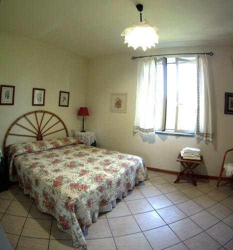 a bedroom with a large bed and a window at Agriturismo Valle Siriaca in Castelnuovo di Porto