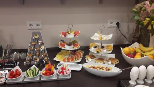 a table topped with lots of different types of food at Hotel Ravene in Cochem