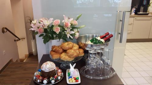 a table with a bunch of food and a vase of flowers at Hotel Ravene in Cochem