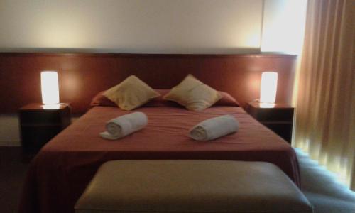 En eller flere senge i et værelse på Hotel Victoria