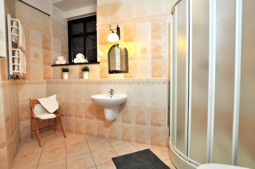 a bathroom with a sink and a shower at Best Location Szewska in Toruń