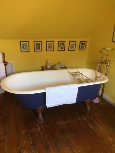 a blue and white bath tub in a room at Lime Trees Farm in Bicester