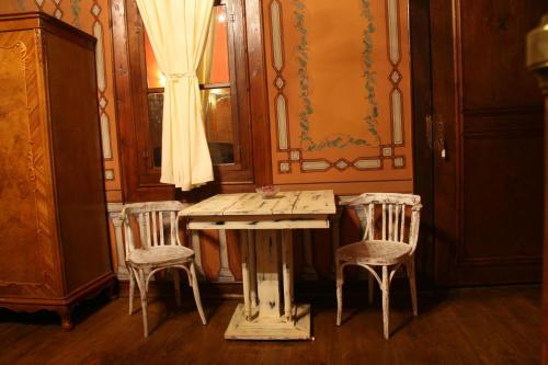 a dining room with a table and two chairs at Guest House Old Plovdiv in Plovdiv