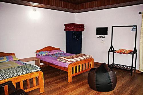 a room with two beds and a mirror at Simply Coorg Estate Villa in Virajpet