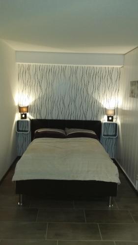 a bedroom with a bed with two lights on it at Studio am Waltenberg in Winterberg