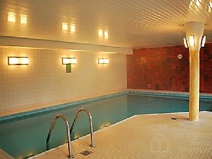 a large swimming pool in a room with at Studio am Waltenberg in Winterberg