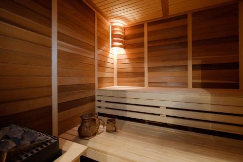 a sauna with a bench in a wooden room at Apart K Apartments in Belgrade