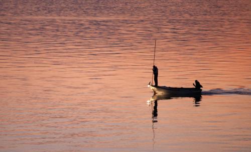 two people in a small boat on the water at Apartment Anastazija in Omiš