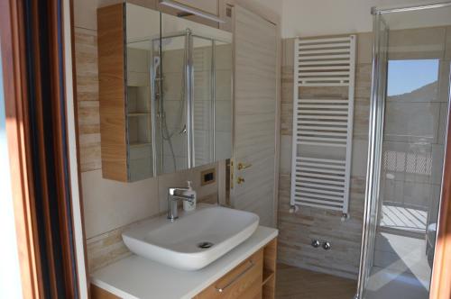 a bathroom with a sink and a shower at Guest House - Il Granaio in Norma