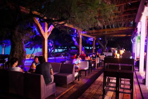 a group of people sitting at a restaurant at night at Apartment Anastazija in Omiš
