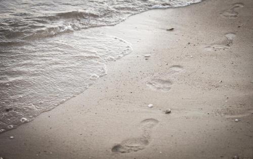 a pair of footprints in the sand on the beach at Apartment Anastazija in Omiš