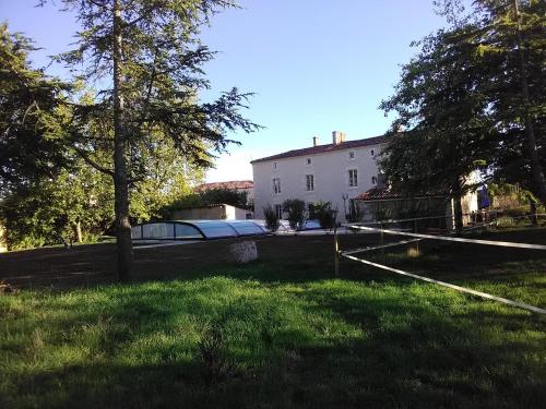 a large white house with trees and a yard at Le Marais Picotin in Saint-Pierre-le-Vieux