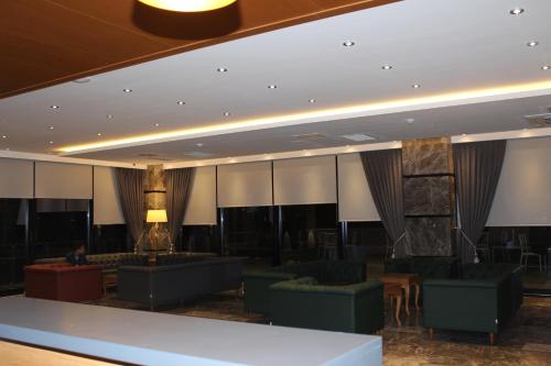 a lobby of a hotel with couches and chairs at Ramada By Wyndham Giresun Piraziz in Piraziz