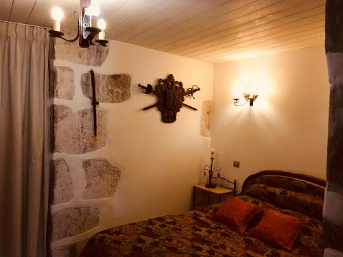 a bedroom with a bed and a stone wall at Lodges du Canal St-Dominique in Annecy