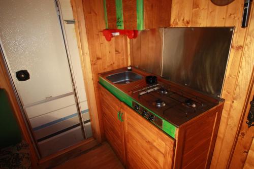 a small kitchen with a stove and a sink at Camping Du Parc in Pré-Saint-Didier