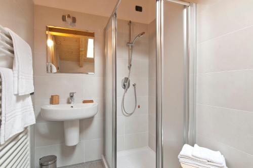 a bathroom with a shower and a sink at Helianthus Residence in Cannero Riviera