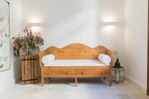 a wooden bench in the corner of a room at S'Hotelet d'es Born - Suites & SPA in Ciutadella