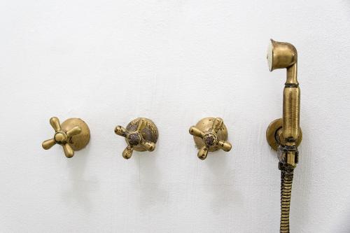 three different types of brass fixtures on a wall at S'Hotelet d'es Born - Suites & SPA in Ciutadella