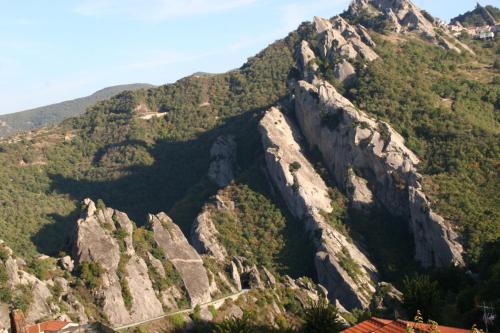 a mountain with rocks and trees on it at Monserrat in Castelmezzano