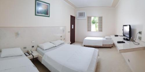 Uma cama ou camas num quarto em Hotel Premier