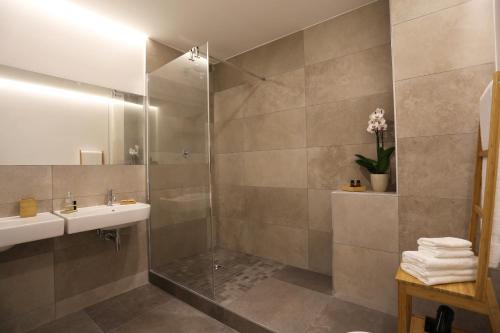 a bathroom with a sink and a shower at Re Ruggero Rooms in Reggio di Calabria