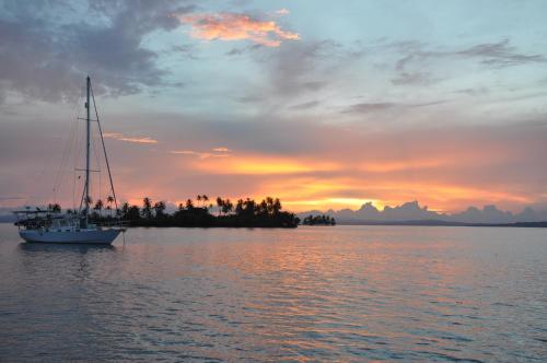 a sail boat in the water at sunset at Play to Live San Blas in El Porvenir