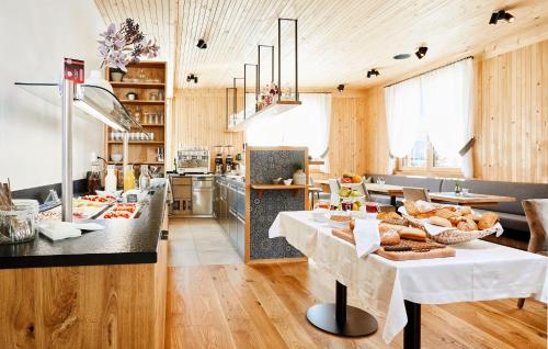 a large kitchen with a table with bread on it at Hotel Gretina in Bezau