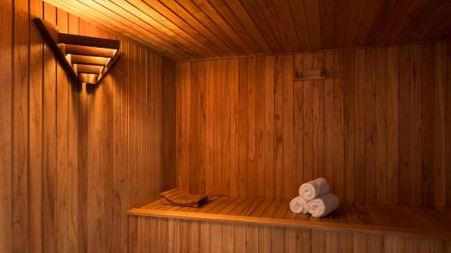 a sauna with two towels sitting on a shelf at Dazzler by Wyndham Puerto Madryn in Puerto Madryn