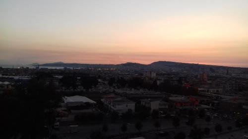 a view of a city at sunset at Palazzo del Mare in Naples